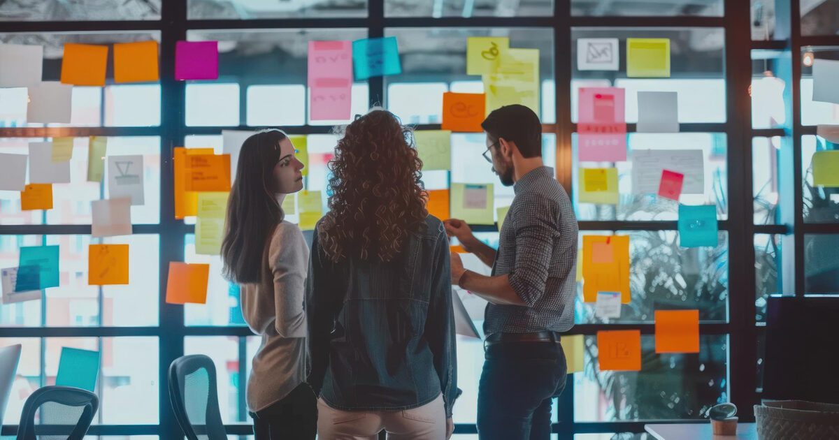 Analytics team collaborating at a planning wall, mapping roles and responsibilities